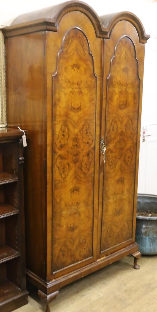 A 1930s figured walnut double dome two door wardrobe W.100cm